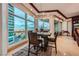 Modern dining room with panoramic views, contemporary lighting, and an adjacent outdoor balcony at 9103 Alta Drive Dr # 407, Las Vegas, NV 89145