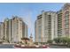Luxury high-rise condominiums featuring an elaborate fountain with landscaped entrance and circular driveway at 9103 Alta Drive Dr # 407, Las Vegas, NV 89145