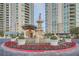 Elaborate fountain with lush landscaping and circular driveway situated between high-rise condominiums at 9103 Alta Drive Dr # 407, Las Vegas, NV 89145