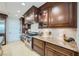 Updated kitchen features granite counters, tile backsplash and dark wood cabinetry at 9103 Alta Drive Dr # 407, Las Vegas, NV 89145