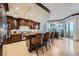 Modern kitchen with granite countertops, stainless steel appliances, breakfast bar, and views of the dining area at 9103 Alta Drive Dr # 407, Las Vegas, NV 89145