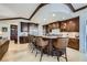 Spacious kitchen with granite counters, central island and dark wood cabinets at 9103 Alta Drive Dr # 407, Las Vegas, NV 89145