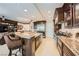 A modern kitchen featuring a central island, granite countertops, and stainless steel appliances at 9103 Alta Drive Dr # 407, Las Vegas, NV 89145