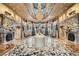 Exquisite lobby with ornate marble floors, decorative fireplaces, crystal chandeliers, and elegant seating at 9103 Alta Drive Dr # 407, Las Vegas, NV 89145