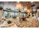 Spacious lounge area with comfortable seating, elegant chandeliers, and panoramic views from large windows at 9103 Alta Drive Dr # 407, Las Vegas, NV 89145