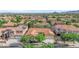 An aerial shot of a beige home with desert landscaping and an orange tile roof in a vibrant neighborhood at 9375 Gold Lake Ave, Las Vegas, NV 89149