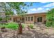 Expansive backyard featuring decorative rocks, grass, desert landscaping, and covered patio at 9375 Gold Lake Ave, Las Vegas, NV 89149