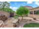 Backyard featuring desert landscaping, bench, mature trees, and outdoor storage at 9375 Gold Lake Ave, Las Vegas, NV 89149