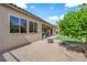 Low maintenance backyard with rock ground cover, mature trees, and outdoor fireplace at 9375 Gold Lake Ave, Las Vegas, NV 89149