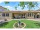 Lush backyard with desert landscaping, mature trees, covered patio, and decorative accents at 9375 Gold Lake Ave, Las Vegas, NV 89149