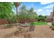 Spacious backyard featuring decorative rock cover, mature trees, and an outdoor seating area at 9375 Gold Lake Ave, Las Vegas, NV 89149