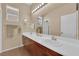 Elegant bathroom with dual sinks, wooden cabinets, large mirror, and recessed lighting at 9375 Gold Lake Ave, Las Vegas, NV 89149