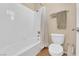 Clean bathroom featuring a shower-tub combo, white tile and modern fixtures at 9375 Gold Lake Ave, Las Vegas, NV 89149