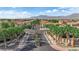 Gorgeous view of the entry to a neighborhood with palm tree landscaping and desert mountain backdrop at 9375 Gold Lake Ave, Las Vegas, NV 89149