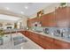 Kitchen features granite counters, wooden cabinetry, and open to living room at 9375 Gold Lake Ave, Las Vegas, NV 89149