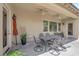 Covered patio featuring ceiling fans, outdoor dining set, and access to backyard at 9375 Gold Lake Ave, Las Vegas, NV 89149