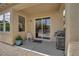 Covered patio with BBQ, seating, and sliding glass door to interior space at 9375 Gold Lake Ave, Las Vegas, NV 89149