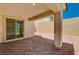 Covered patio overlooking the gravel backyard and block wall at 10024 Rams Leap Ave, Las Vegas, NV 89166