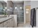 Elegant bathroom features a granite countertop vanity, glass-enclosed shower with gray tiling and mosaic accents at 10024 Rams Leap Ave, Las Vegas, NV 89166