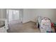 Neutral carpeted bedroom with open doorway and play area at 10024 Rams Leap Ave, Las Vegas, NV 89166