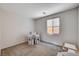 Bright bedroom with neutral carpet, ample natural light and cozy play area for children at 10024 Rams Leap Ave, Las Vegas, NV 89166