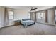 Spacious bedroom features plush carpeting, a ceiling fan, and plenty of natural light from the large windows at 10024 Rams Leap Ave, Las Vegas, NV 89166