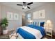 Virtually staged bedroom with blue bedding, stylish decor and modern lighting at 10024 Rams Leap Ave, Las Vegas, NV 89166