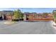 Secured community entrance with decorative metal gate, landscaping, and signage at 10024 Rams Leap Ave, Las Vegas, NV 89166