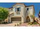 Charming two-story home boasts tan stucco, a red tile roof, a two-car garage, and desert landscaping at 10024 Rams Leap Ave, Las Vegas, NV 89166