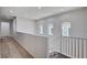 Hallway with carpet, white railings, arched windows and neutral paint at 10024 Rams Leap Ave, Las Vegas, NV 89166