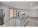 Spacious kitchen island features granite countertop, seating, and storage cabinets at 10024 Rams Leap Ave, Las Vegas, NV 89166