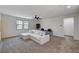 Spacious living room featuring a ceiling fan, comfortable seating, and two windows at 10024 Rams Leap Ave, Las Vegas, NV 89166