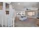 Bright, open-concept living room with neutral carpet, large windows, and modern ceiling fan at 10024 Rams Leap Ave, Las Vegas, NV 89166