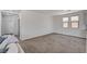 Bright and airy living area with neutral carpet and large windows at 10024 Rams Leap Ave, Las Vegas, NV 89166