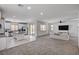 Spacious open-concept living room and kitchen area with stainless steel appliances and tile flooring at 10024 Rams Leap Ave, Las Vegas, NV 89166