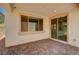Outdoor patio area with tiled flooring and sliding door at 10024 Rams Leap Ave, Las Vegas, NV 89166