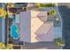 Aerial view of home showcasing the roof, desert landscape, swimming pool, and backyard pergola at 10058 Saint Augustine St, Las Vegas, NV 89183