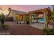 Enjoy backyard relaxation in this desert landscape featuring a pool, patio area, and pergola at 10058 Saint Augustine St, Las Vegas, NV 89183