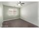 Bedroom featuring neutral walls and carpet flooring, with a ceiling fan and window at 10058 Saint Augustine St, Las Vegas, NV 89183