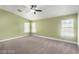 Bright bedroom with three windows, carpet, and a ceiling fan that provide natural light and ventilation at 10058 Saint Augustine St, Las Vegas, NV 89183