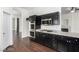 Well-equipped kitchen featuring stainless steel appliances, dark wood cabinets, and easy access to living spaces at 10058 Saint Augustine St, Las Vegas, NV 89183