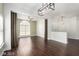 Open-concept living area with hardwood floors, neutral paint, and modern light fixture at 10058 Saint Augustine St, Las Vegas, NV 89183