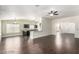 Open living space showcases dark wood flooring, seamless flow to the kitchen and elegant archway entrance at 10058 Saint Augustine St, Las Vegas, NV 89183