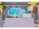 Aerial view of a backyard pool with colorful sunshades and desert landscaping in a private residence at 10058 Saint Augustine St, Las Vegas, NV 89183