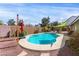 Sparkling pool is surrounded by desert landscaping with a covered pergola for backyard shade at 10058 Saint Augustine St, Las Vegas, NV 89183