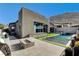Contemporary backyard with a pool, fire pit, and views of the surrounding desert landscape at 10228 Shell Star Ave, Las Vegas, NV 89135