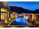 Backyard with a sparkling pool, spa and elegant water feature at night at 10228 Shell Star Ave, Las Vegas, NV 89135
