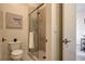 Bathroom featuring a glass-enclosed shower, toilet, and towel rack, next to the exit door at 10228 Shell Star Ave, Las Vegas, NV 89135