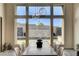 Bright dining area with statement light fixture and floor-to-ceiling windows overlooking the backyard oasis at 10228 Shell Star Ave, Las Vegas, NV 89135