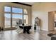 Elegant dining room with modern light fixture and views of the meticulously landscaped backyard at 10228 Shell Star Ave, Las Vegas, NV 89135